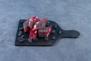 Raisins and Turkish delights in a cutting, on the marble background. High quality photo